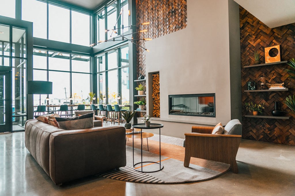 a living room with a leather couch and a fireplace