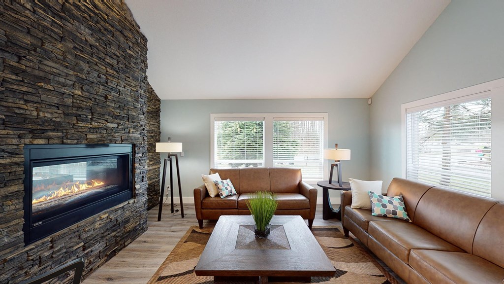 a living room with a fireplace and couches