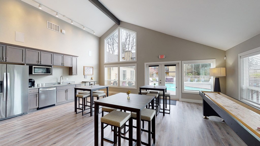 a kitchen and dining room with a table and chairs