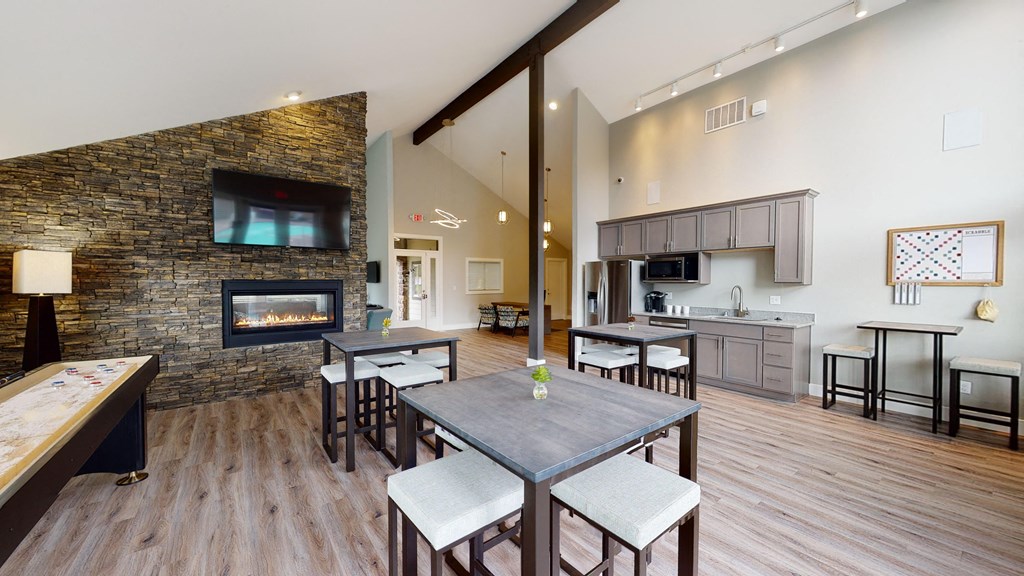 a living room with a fireplace and a dining table