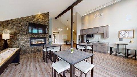 a living room with a fireplace and a dining table