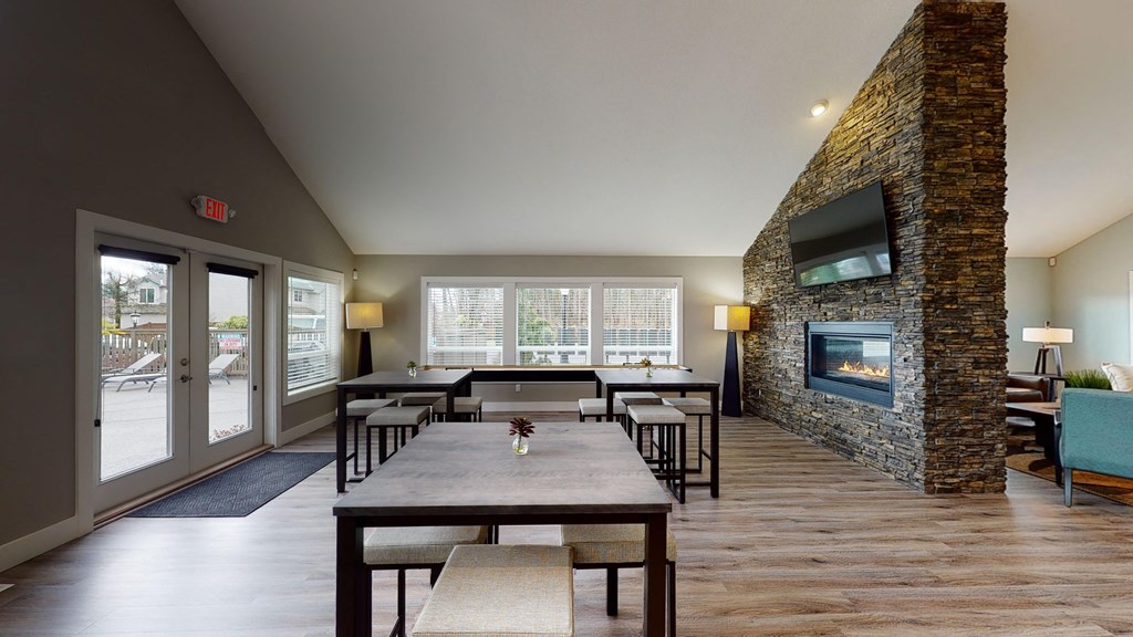a dining room with tables and chairs and a fireplace