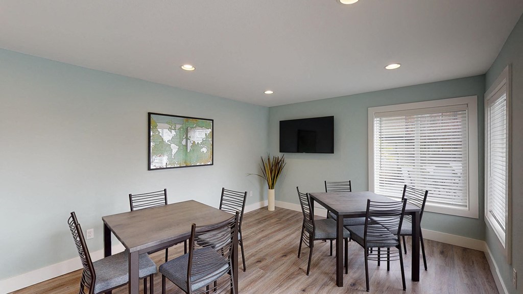a dining room with a table and chairs and a television