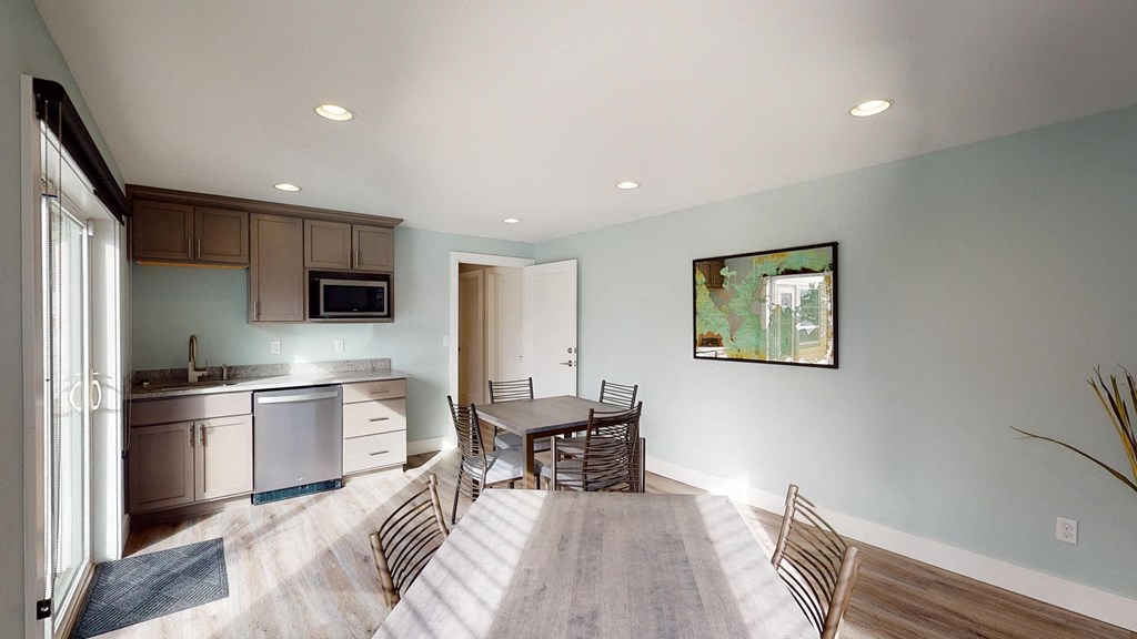a dining room and kitchen with a table and chairs