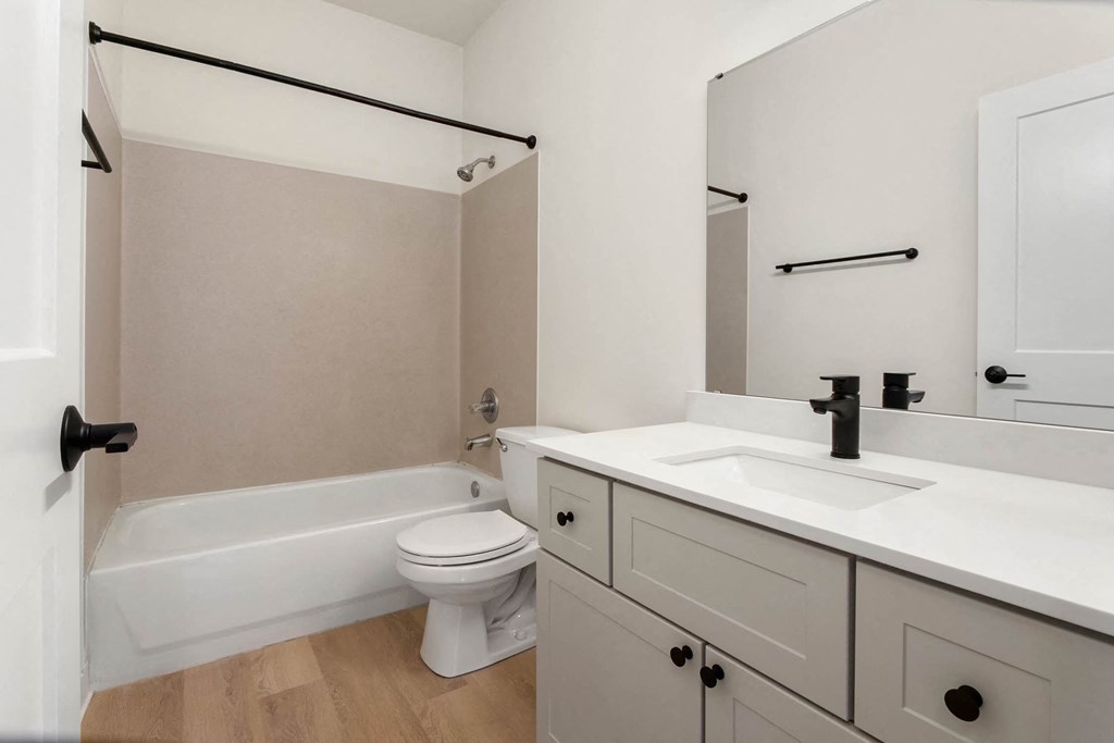 a bathroom with a sink toilet and a bath tub