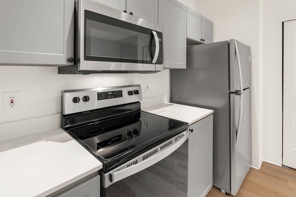 a kitchen with a stove microwave and refrigerator