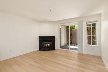 a living room with a fireplace and a sliding glass door