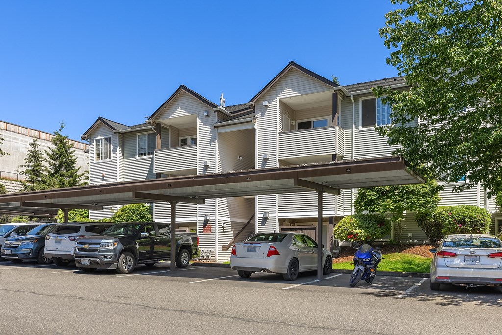 an apartment building with cars parked in front of it