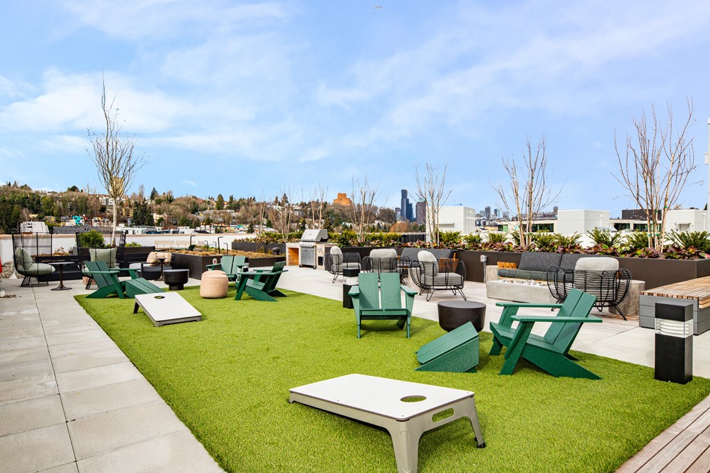 A green lawn with a white table and chairs.