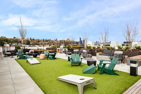 A green lawn with a white table and chairs.