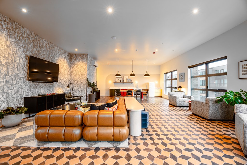 A living room with a stone wall and a checkered floor.