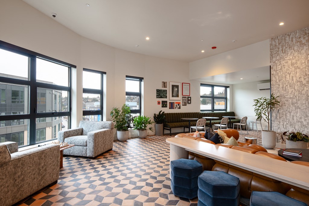 A large room with a checkered floor and a long counter.
