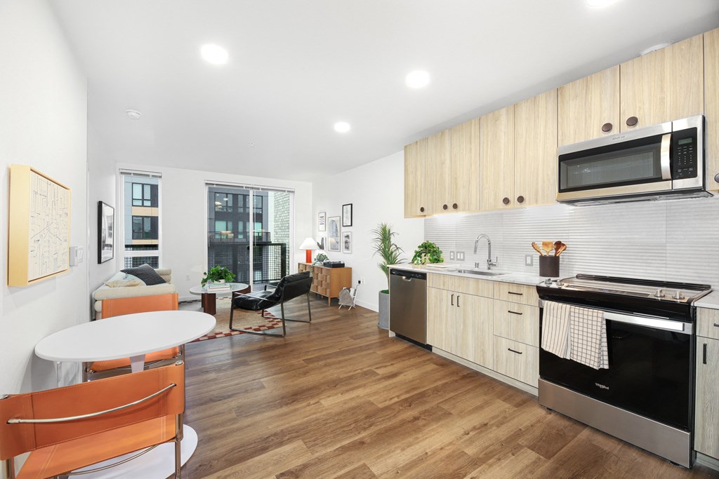 A modern kitchen with wooden cabinets and a white table.