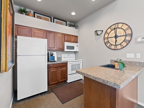 a kitchen with a granite counter top and a white refrigerator