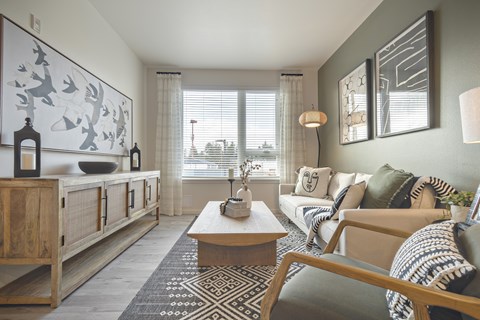 A living room with a wooden cabinet, a sofa, a coffee table, and a rug.
