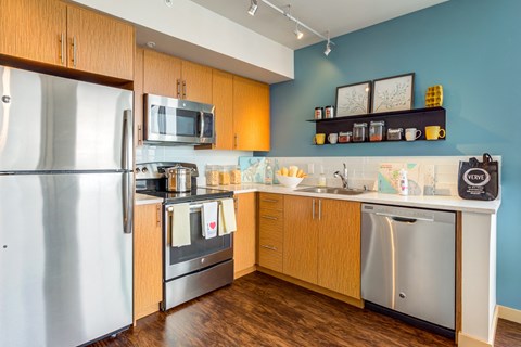 a kitchen with stainless steel appliances and wooden cabinets