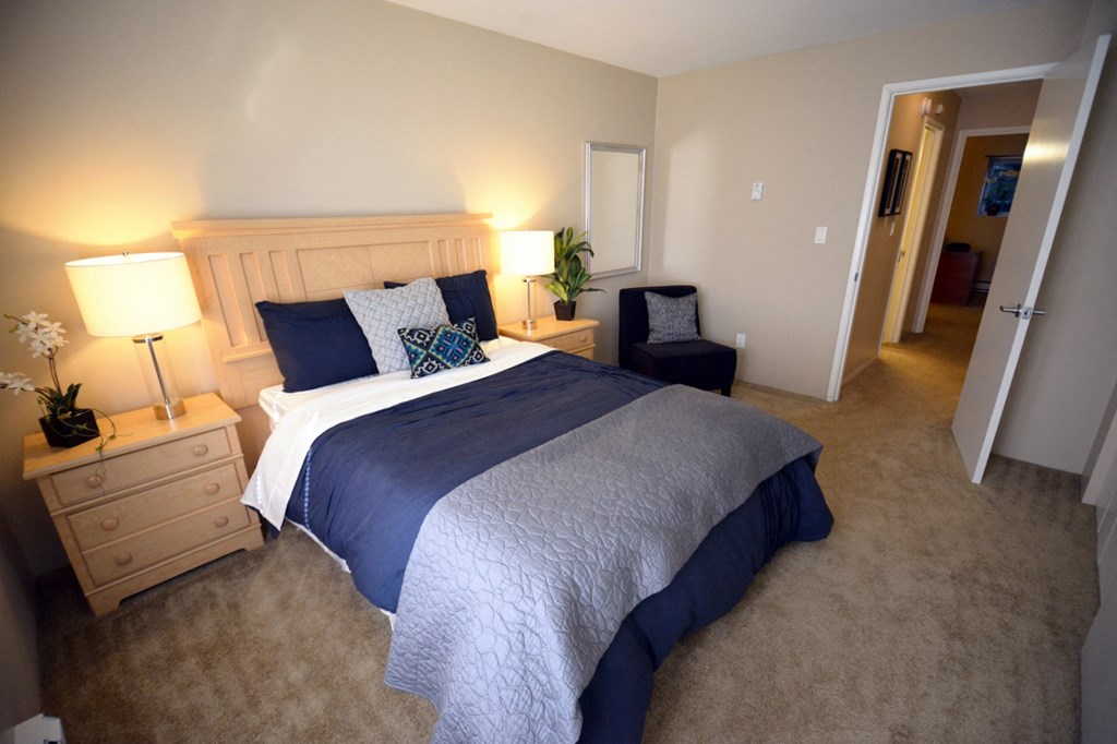 a bedroom with a bed and a chair and a closet