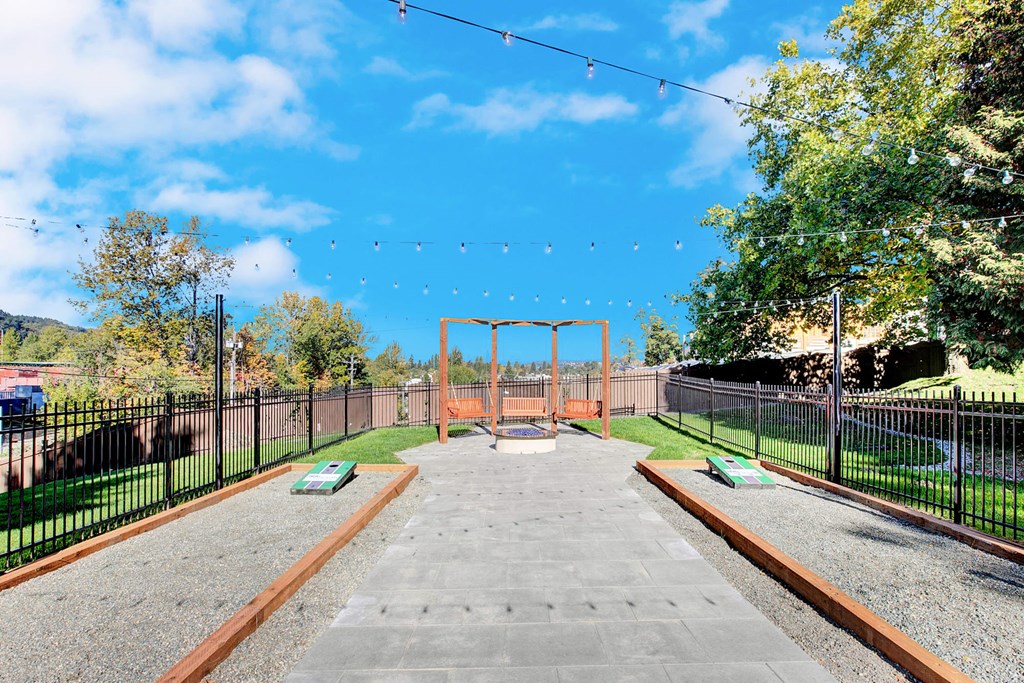 the dog park is fenced in with a chain link fence