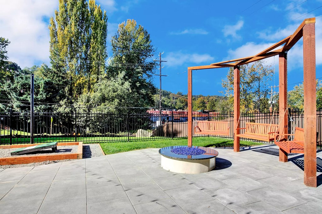 a park with a playground and a fire pit