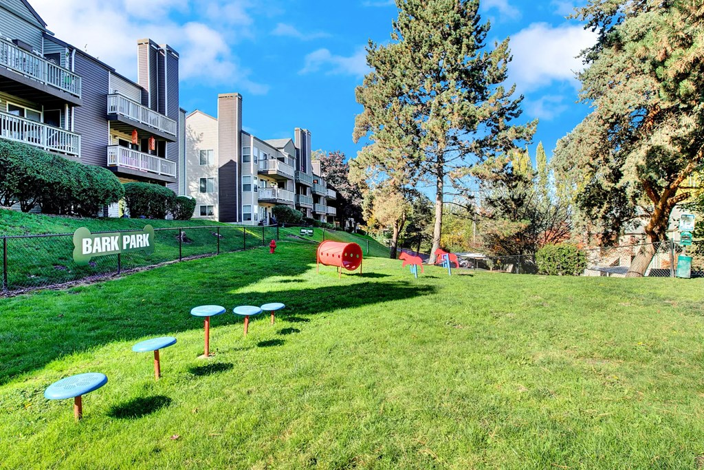 a park with tables and benches in the grass