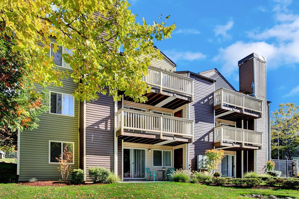 the exterior of an apartment building with balconies and trees
