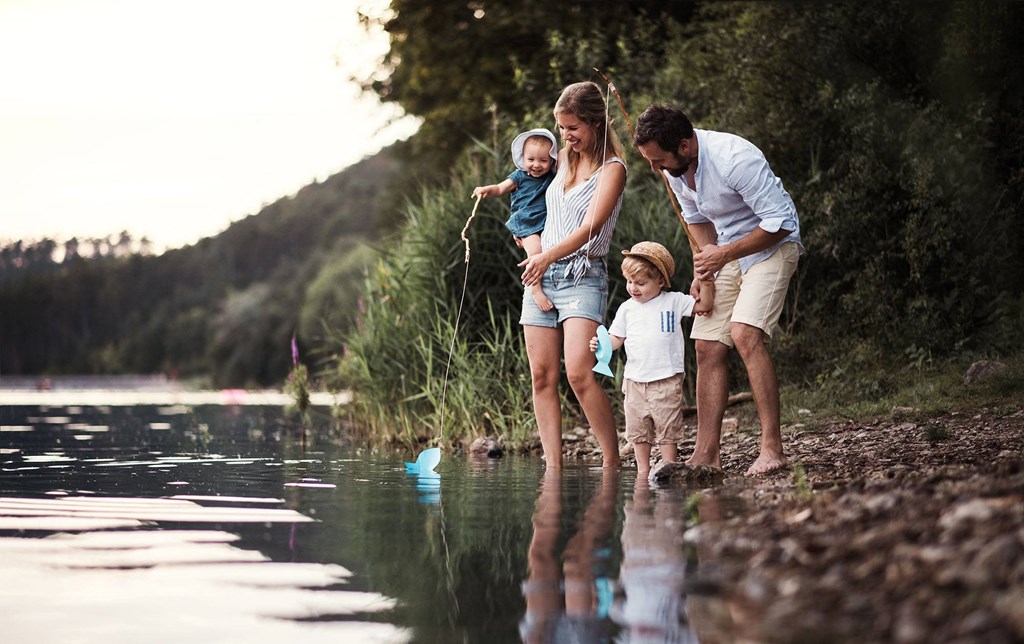 a family playing by the river