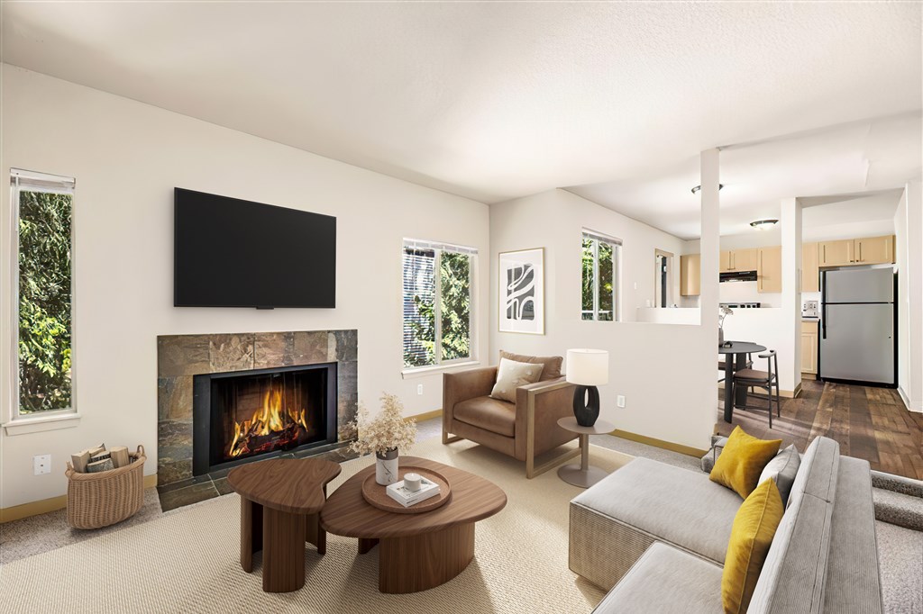 A modern living room with a fireplace and a flat screen TV mounted on the wall.