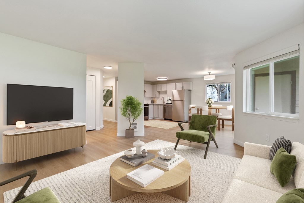 A modern living room with a flat screen TV, a coffee table, and a green armchair.