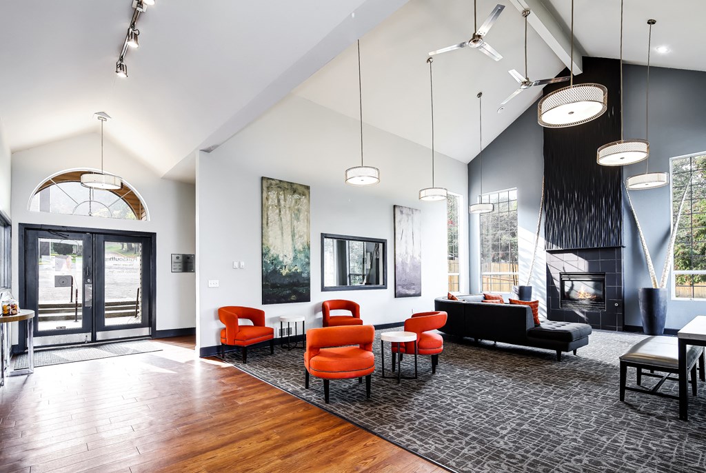 a living room with chairs and a table and a fireplace