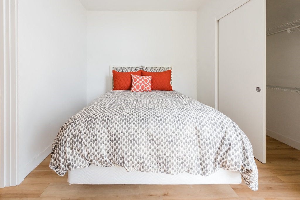 a bedroom with a bed and white walls