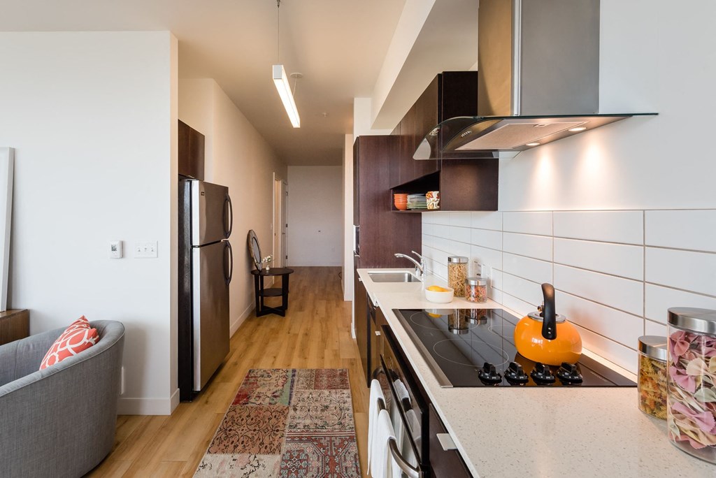a kitchen with a stove top oven next to a refrigerator