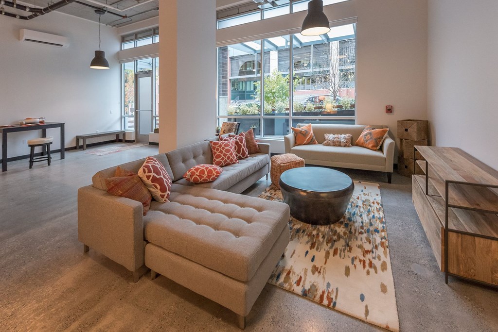 a living room with couches and a coffee table in front of a large window