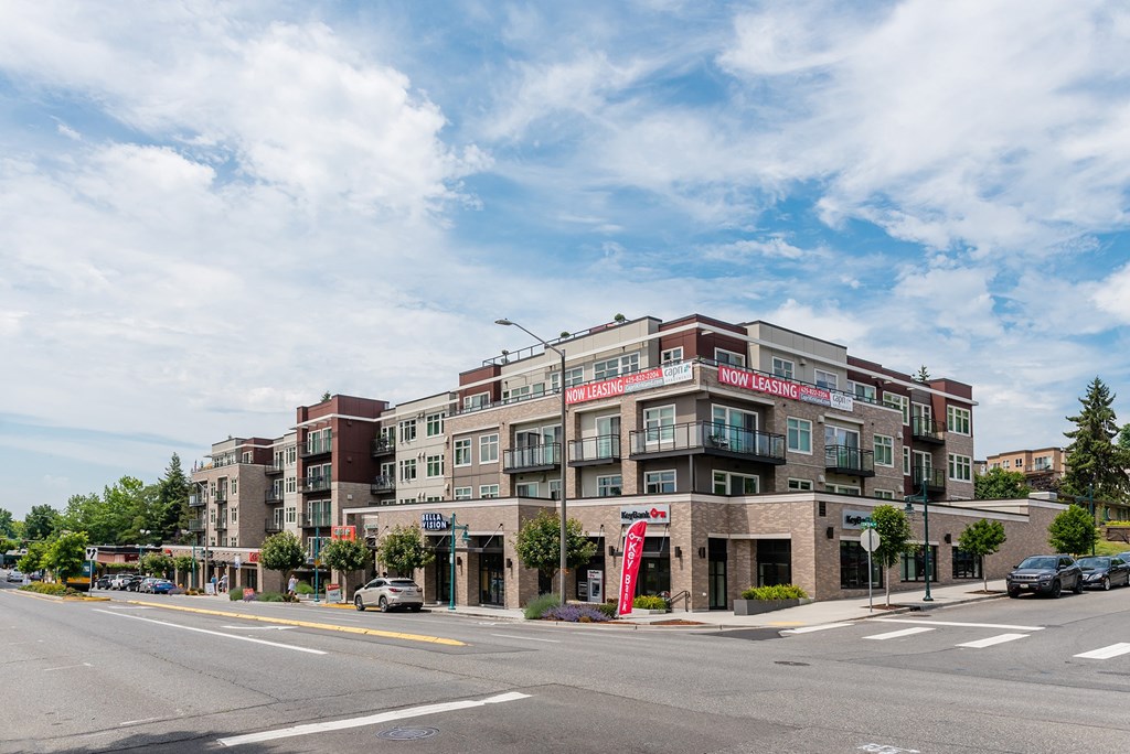 a large brick building with a red and white sign on the side of it