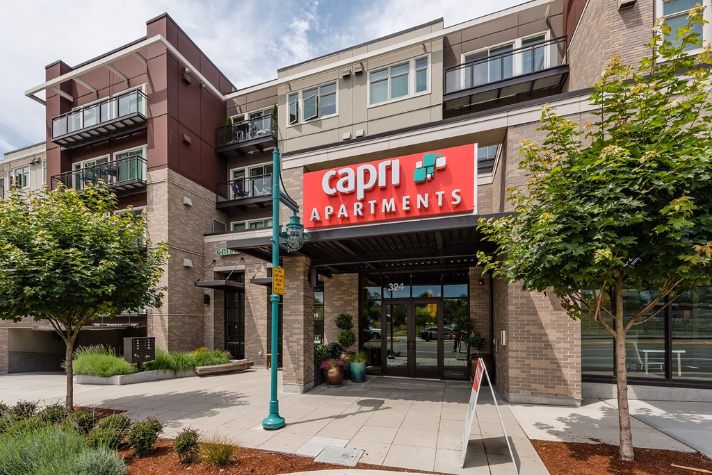 a building with a red sign that reads capital apartments
