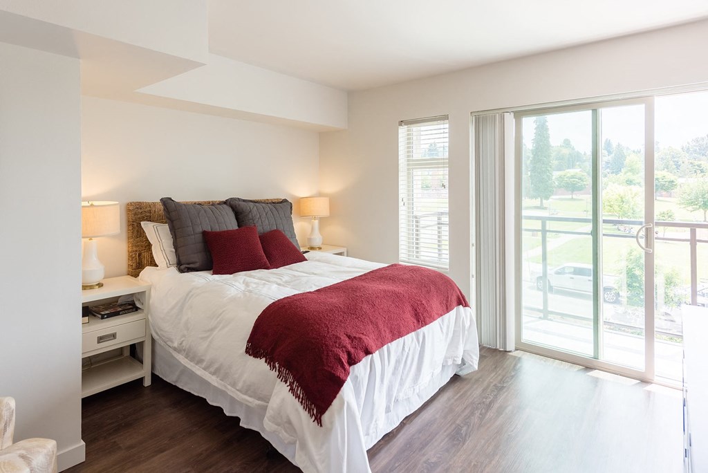 a bedroom with a bed and a sliding glass door
