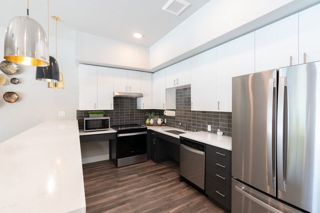 a kitchen with stainless steel appliances and white cabinets
