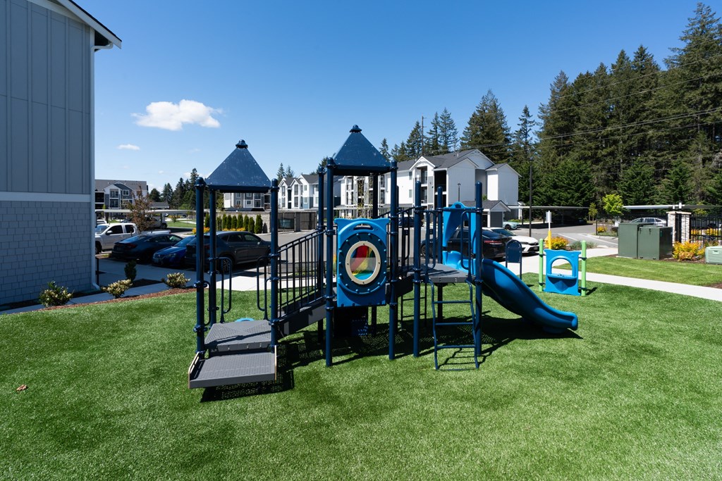 a playground on the yard of a building with a bullseye on it
