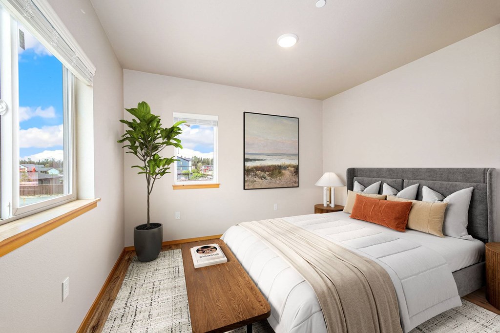 a bedroom with a large bed and a large window