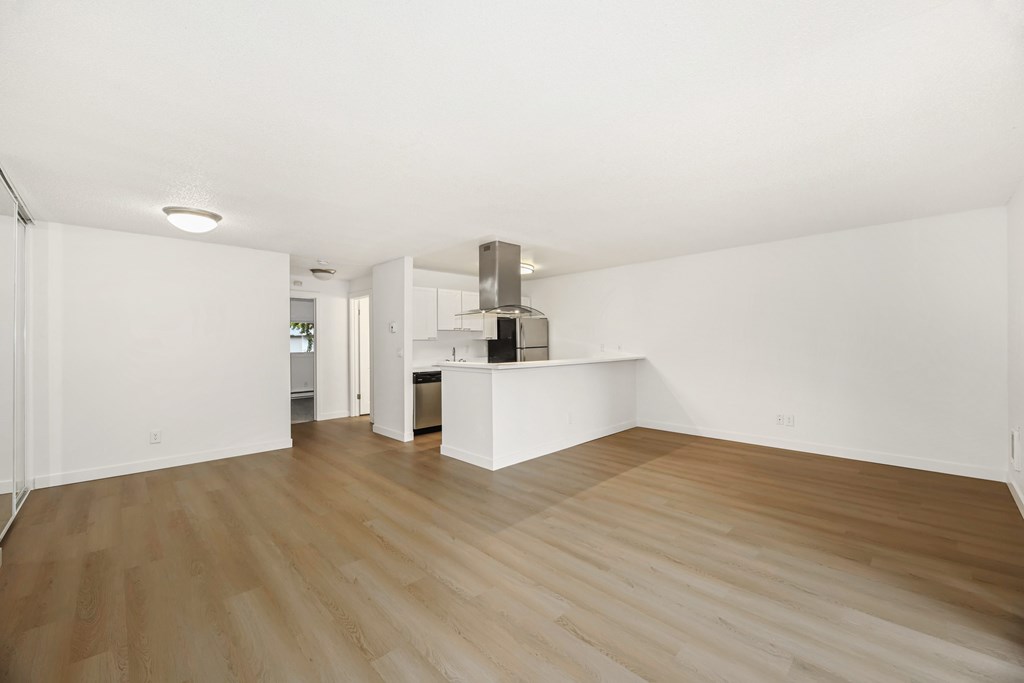 A room with wooden floors and white walls.