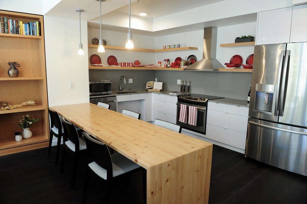 a kitchen with stainless steel appliances and a wooden table