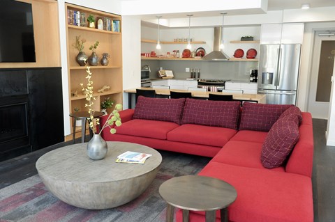 a living room with a red couch and a coffee table