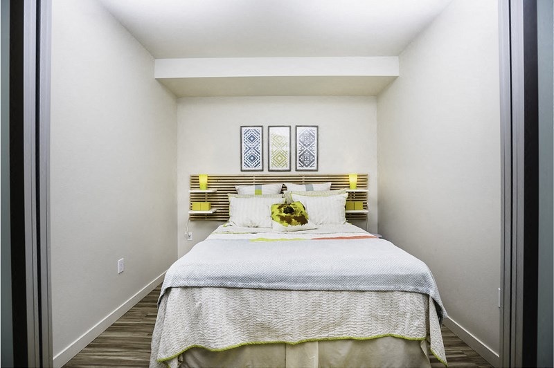 a bedroom with a white bed and a yellow headboard