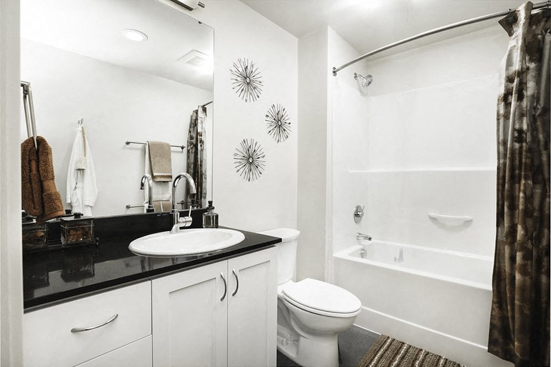 a bathroom with a sink toilet and a shower