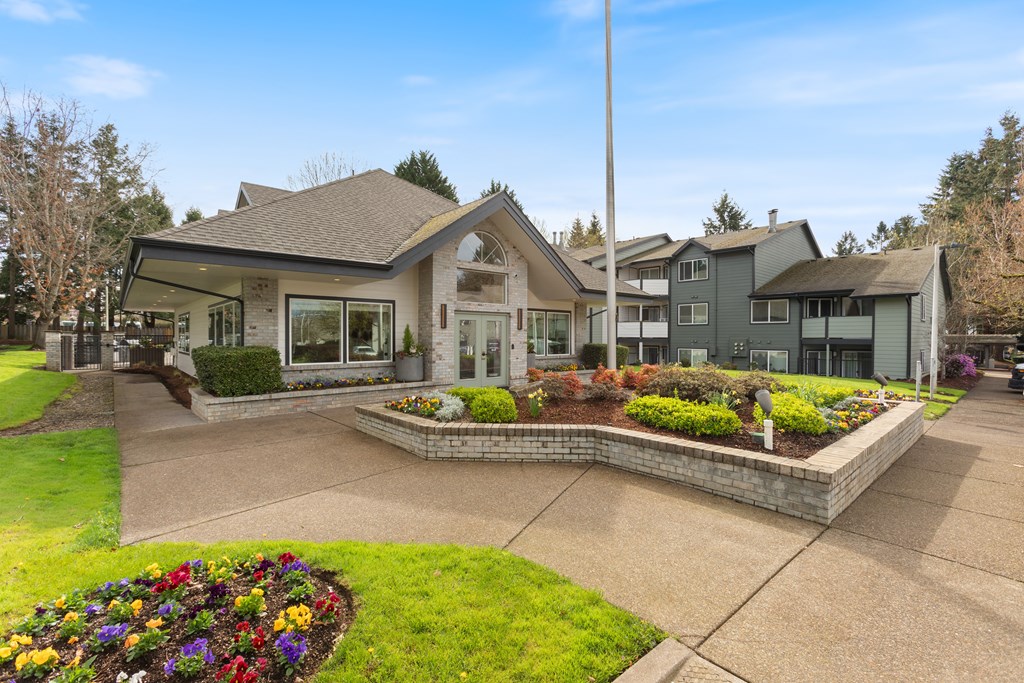 A house with a front yard and a flower bed.