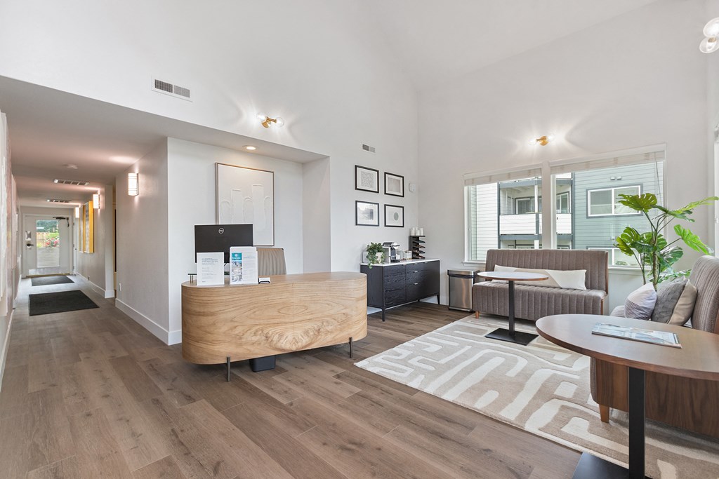 A modern living room with a wooden reception desk and a couch.