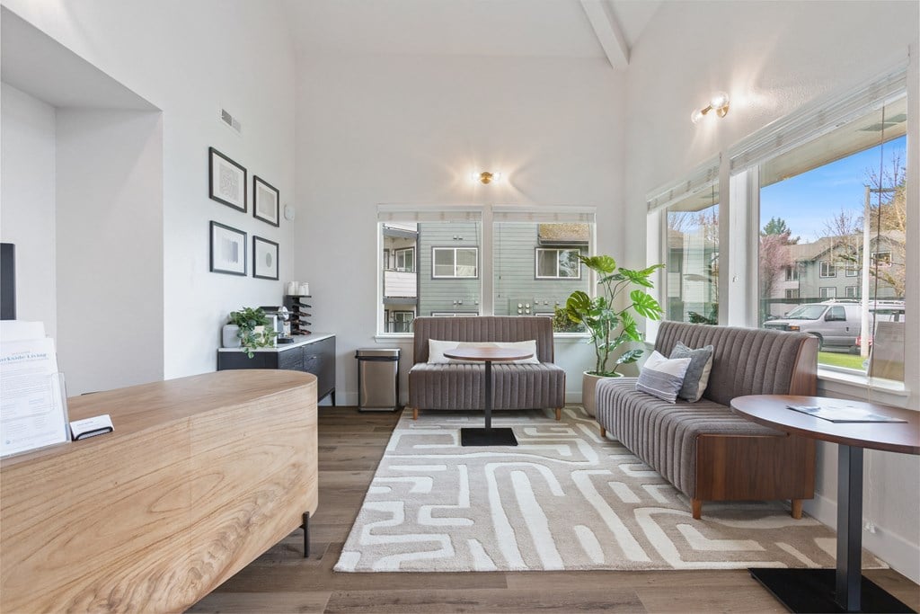 A well-lit living room with a couch, chair, and coffee table.