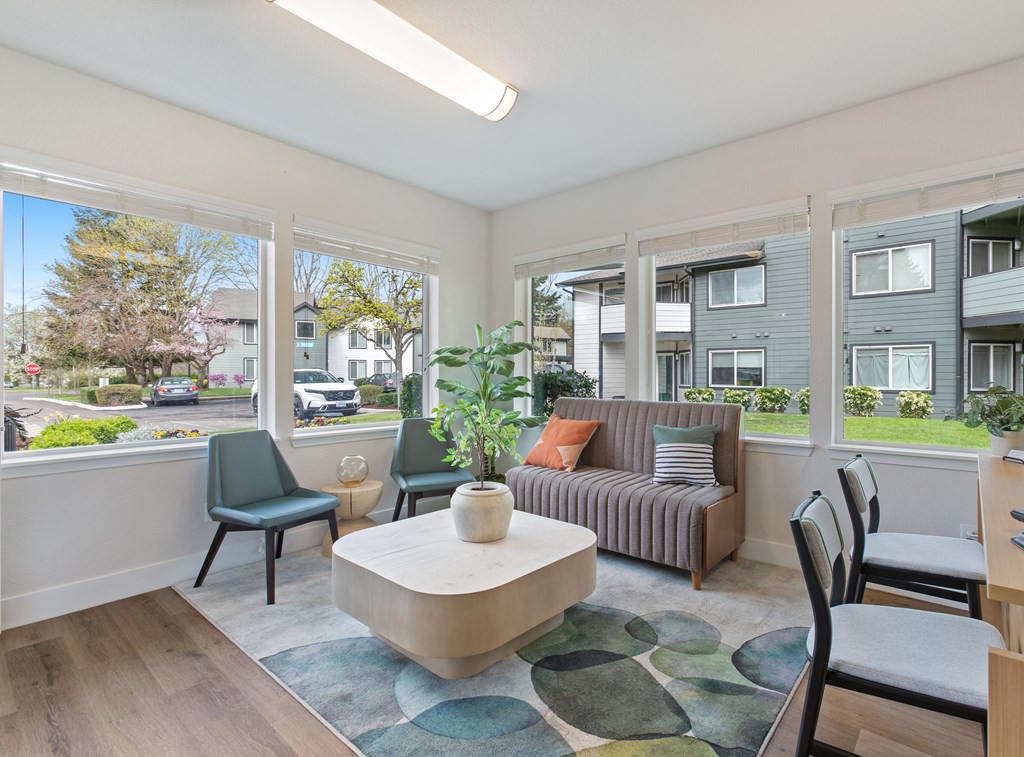 A living room with a couch, chairs, and a coffee table.