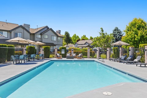 A large swimming pool in front of a resort.