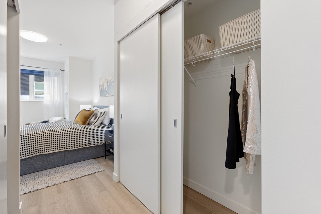 A bedroom with a bed, a wardrobe, and a window.