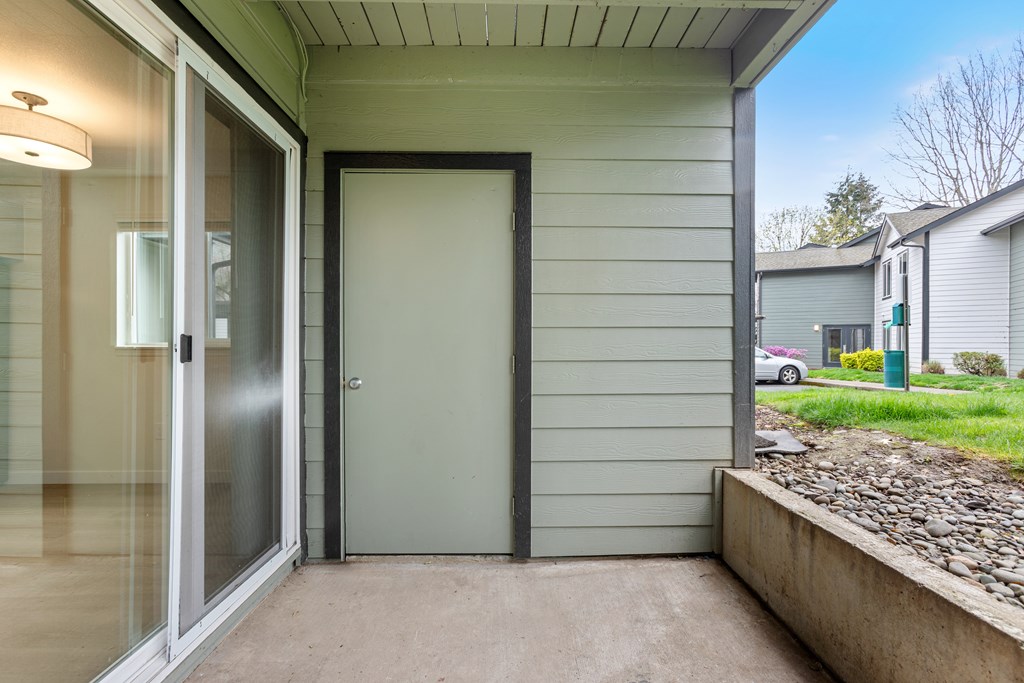 A grey door is closed with a black frame.